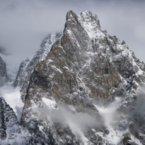 Foto Berglandschaft - Aiguille Noire de Peuterey im Mont-Blanc-Massiv taucht aus den Wolken auf, ein Alpengipfel auf 3773m Höhe, umgeben von Nebel - Fotos felsige Berge