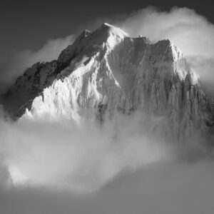 Schwarz-Weiß-Foto der Aiguille Verte und der Alpengipfel Chamonix in Wolken und Nebel nach einem Schneesturm.