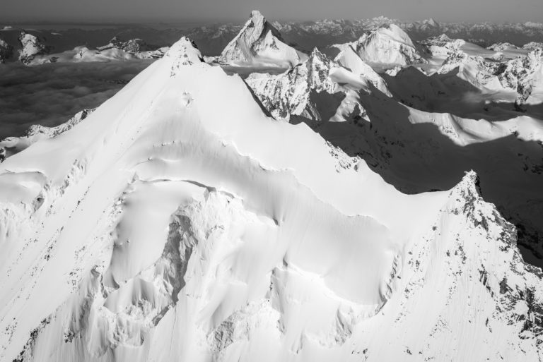 Black and white image of the snow capped mountain peaks of the Weisshorn North Ridge