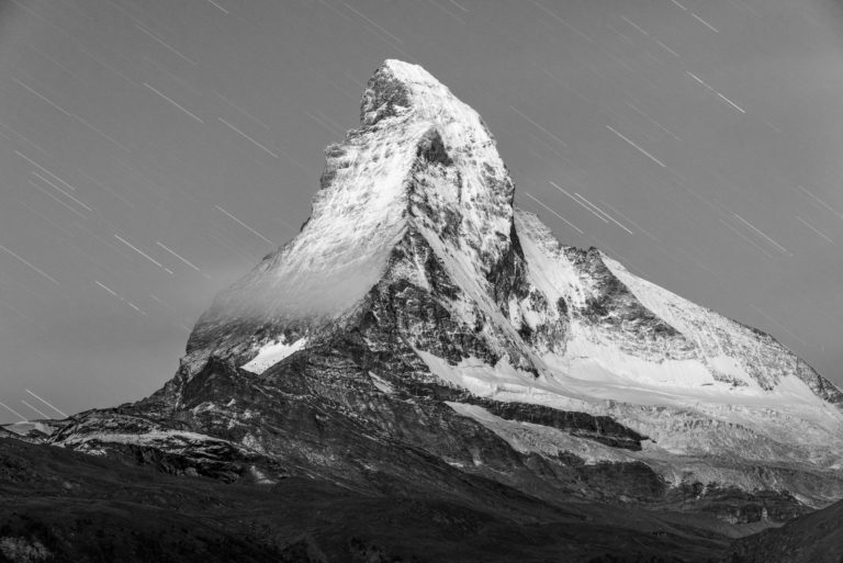 Shooting stars rain on the The Matterhorn  - Black and white mountain picture at night on a snowy rocky summit