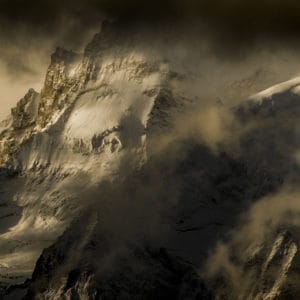 Photo Val d&#039;Anniviers mountain scenery - Dent Blanche - Grand Cornier emerging from golden clouds at sunrise, emblematic mountains of the Valais Alps.