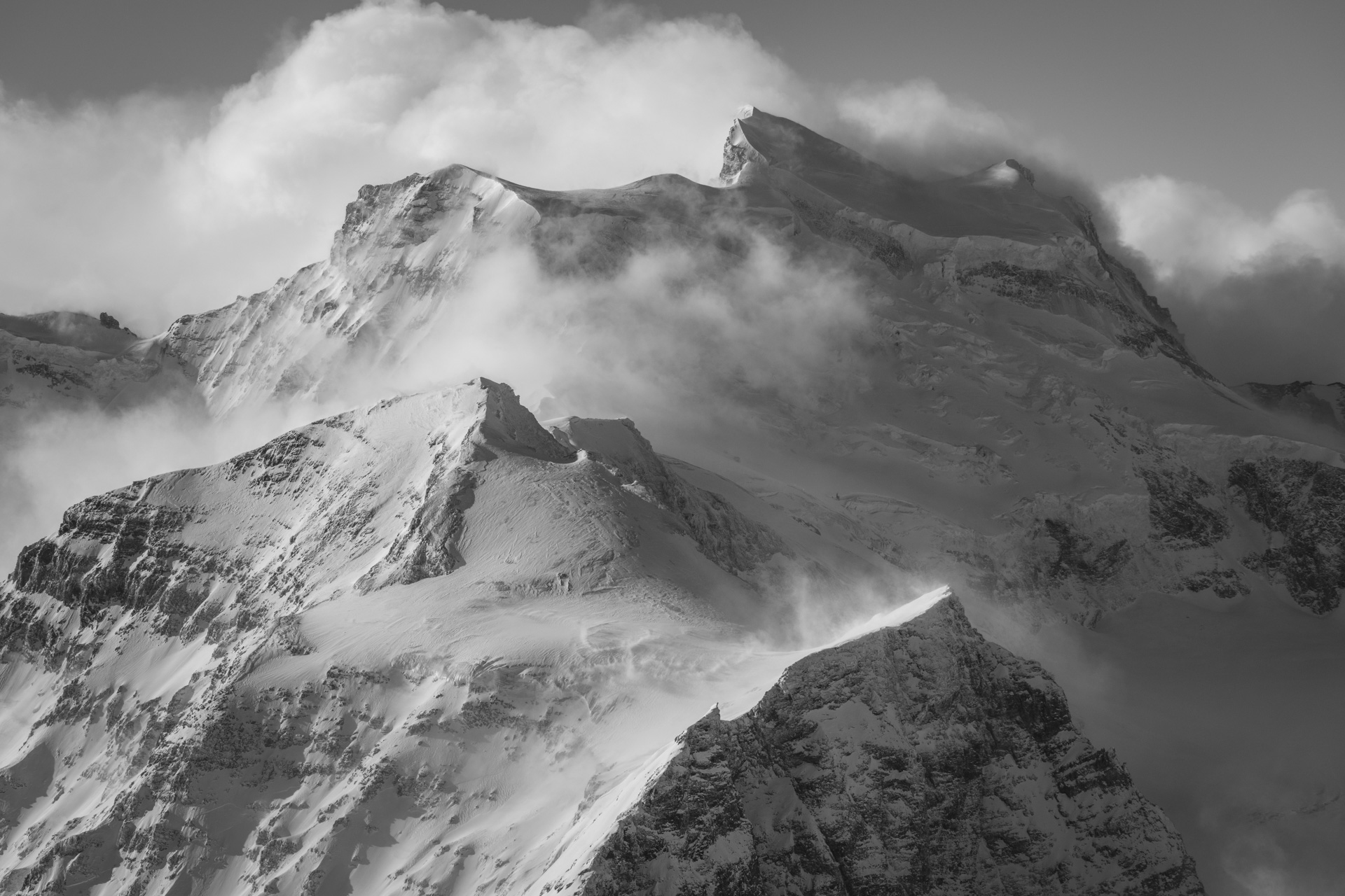 Grand Combin - black and white moutains of high peaks in the swiss  Alps with sea of foggy cloud after a snowstorm in the mountains