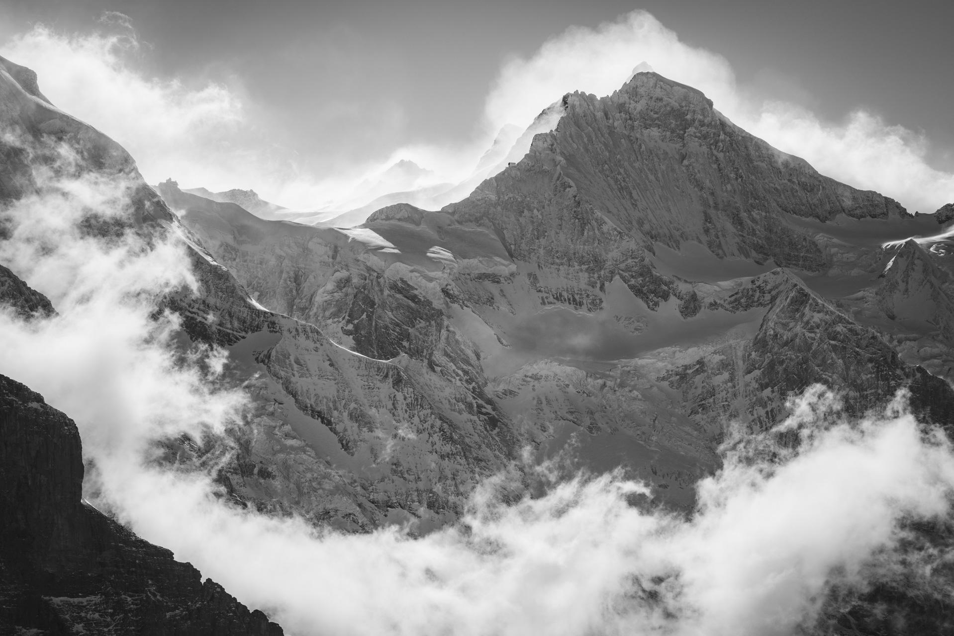 Jungfrau - Black and white mountain range - Mountain in the mist under the sun of bernese alps in Switzerland