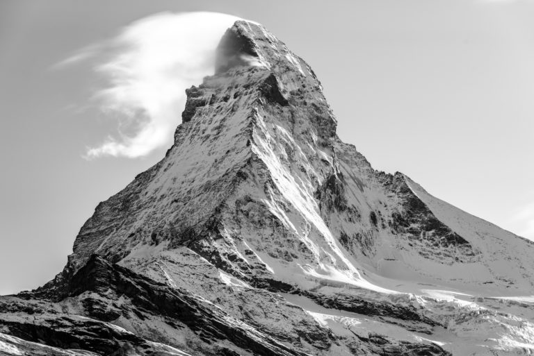 Matterhorn peak summit in smoke in the clouds - The Matterhorn - Zermatt - Swiss mountains in snow in the canton of Valais