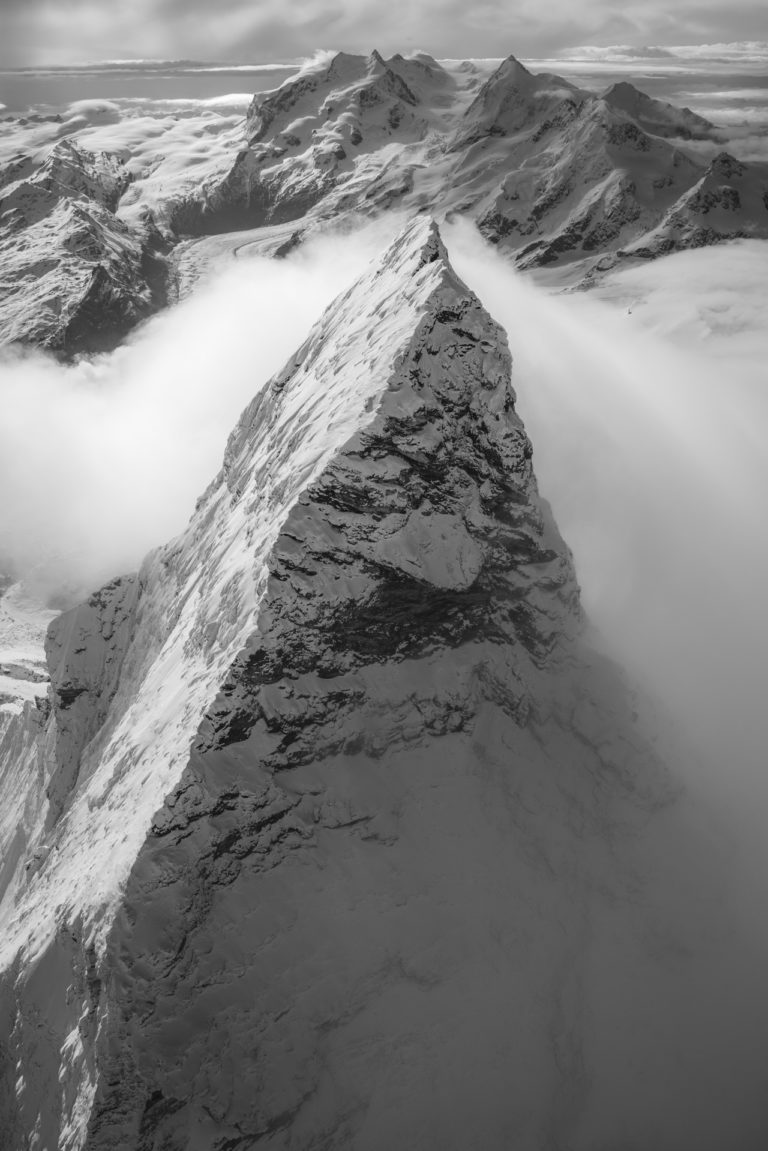 The Matterhorn north face - Mont Cervin west face - Monte Rosa - summit of mountain over clouds