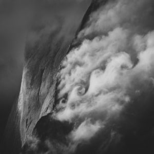 Swiss mountain photo in Engadine - Piz Badile in a sea of clouds - Black and white photo of a mountain range in the Alps