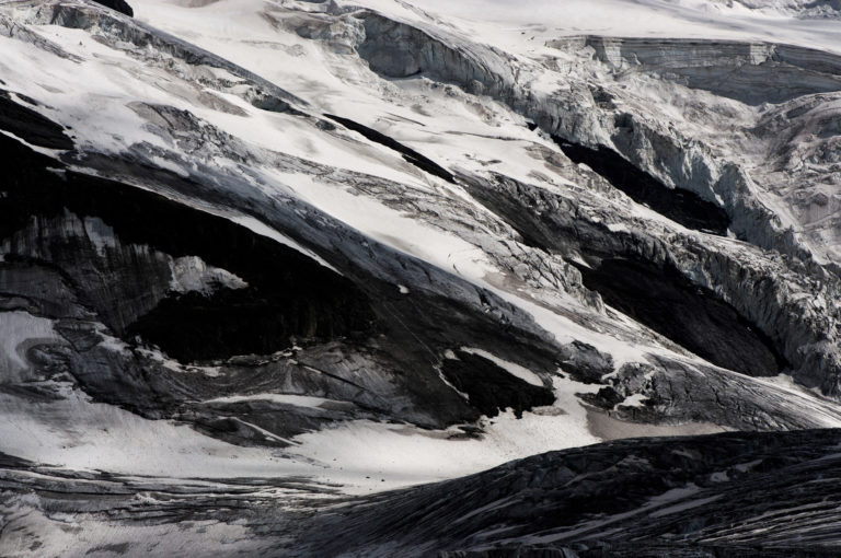 Image of a rocky mountain landscape and a glacier in the Valais Alps in black and white - Seracs of Grand Combin under the snow in Switzerland