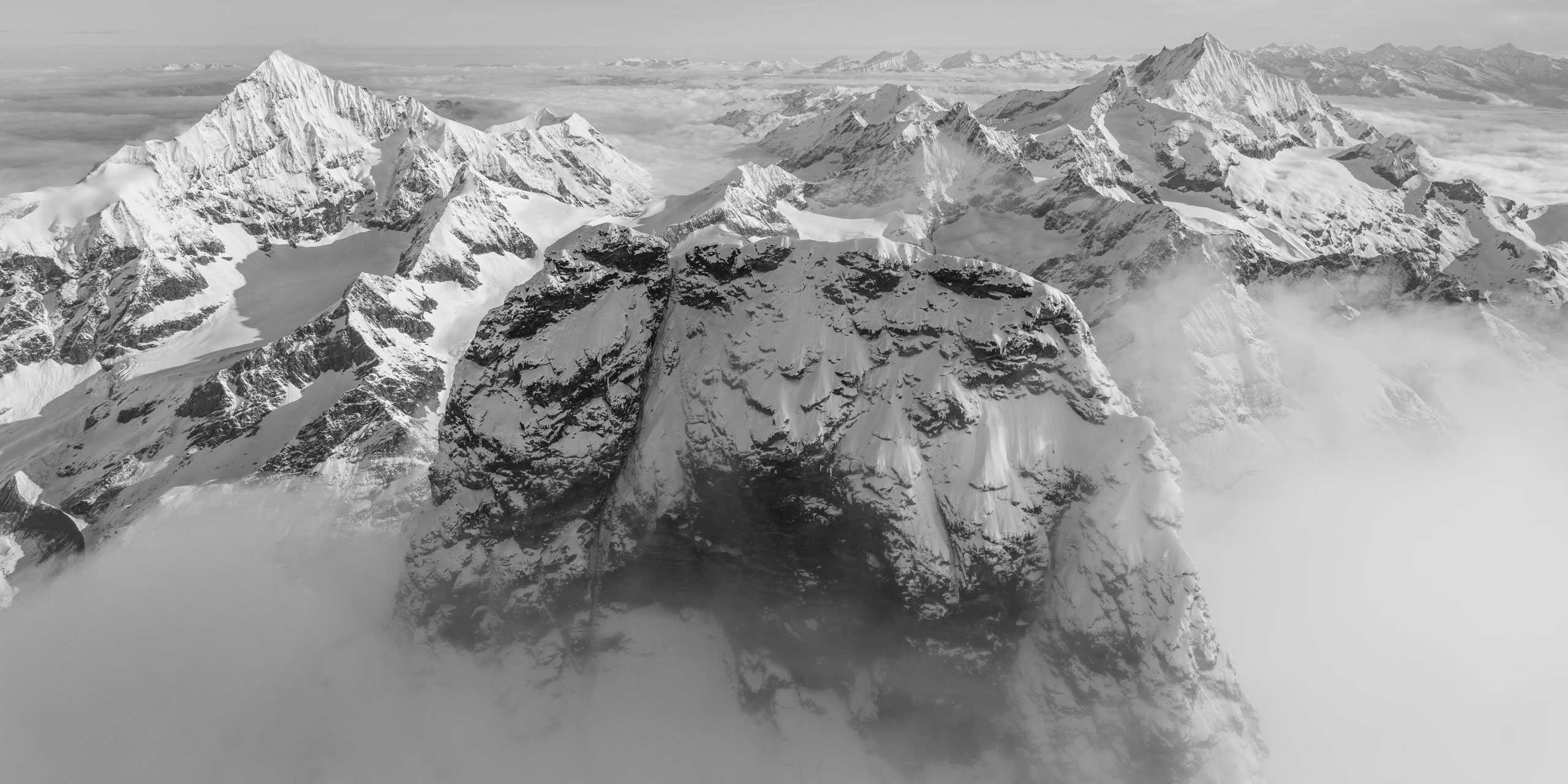 Panorama of Swiss mountain peaks and Matterhorn in the clouds