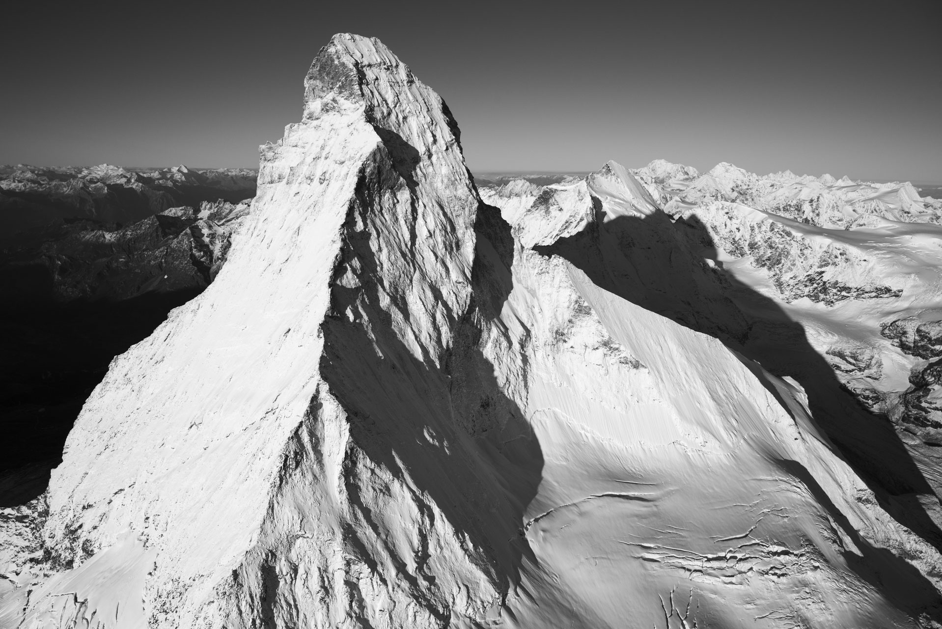 Matterhorn Mont Cervin photos - Black and white photo of snow-capped mountains in the sun