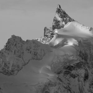Black and white photo of the Zinalrothorn, its glaciers, seracs and crevasses, from the val d’Anniviers in the Swiss Alps.