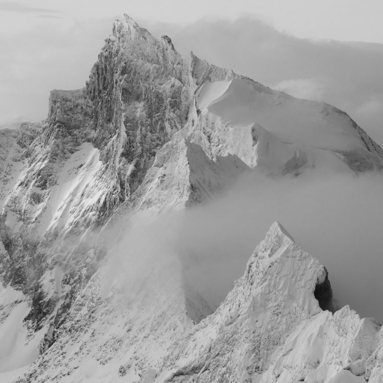 black and white mountains image of the Zinalrothorn peak in a Swiss Alps fog