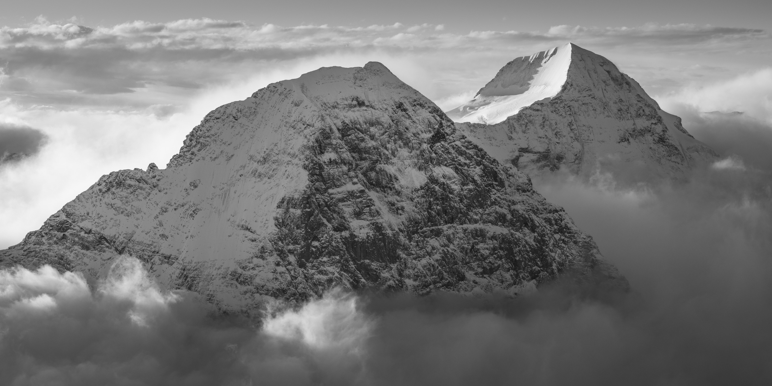 The Eiger north face photos  - The Eiger monch - Black and white mountain with Sea of clouds 