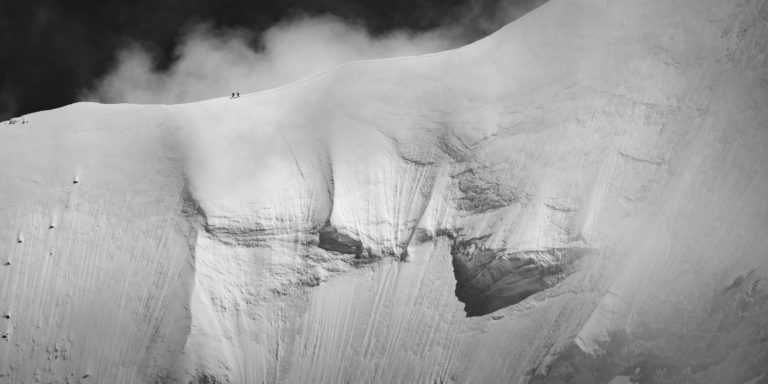 mountaineer photo on snow ridge