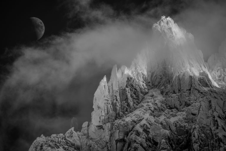 black and white mountains and the moon