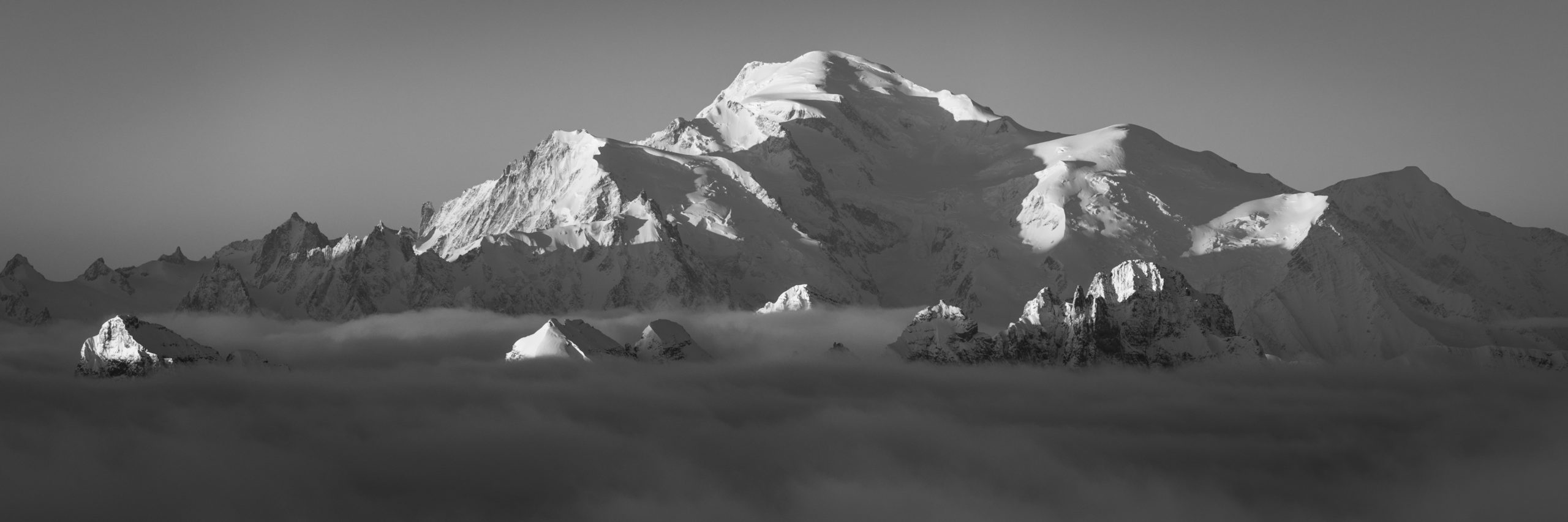 panoramic Mont-Blanc massif - black and white photo - mountain above the sea of clouds