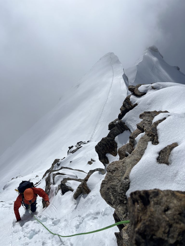 Alpiniste remontant une pente de neige en direction de la Pyramide Vincent