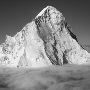 Black and white photograph of the Dent Blanche in the Valais Alps emerging from a sea of clouds after a storm.