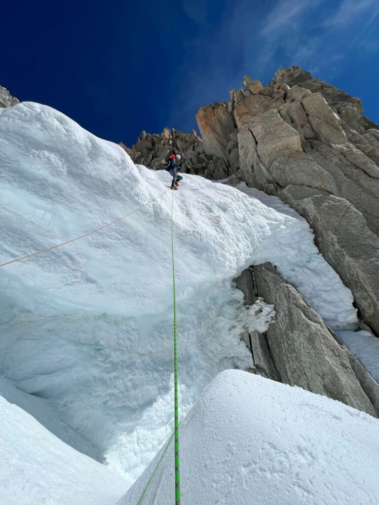 Mountaineer abseiling down the Whymper couloir on the Aiguille Verte in the Mont Blanc massif.